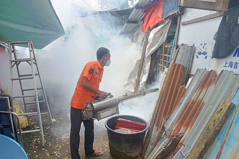 Volunteers from Shwe Yaung Myitta Foundation, a local charity in Sittwe, spray around houses as a dengue fever mitigation measure on August, 31, 2023.